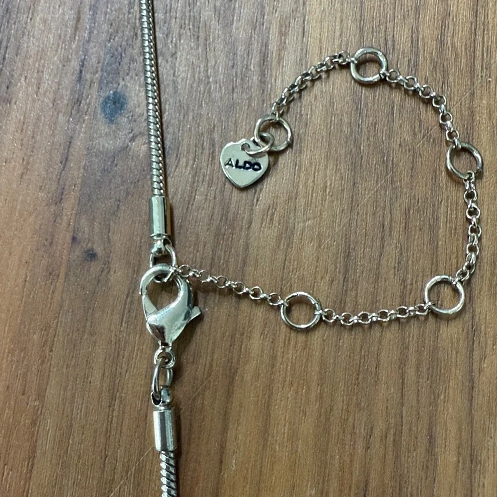 Aldo Gold Tone Clear Rhinestone Long Necklace with Leaf Feather Pendant